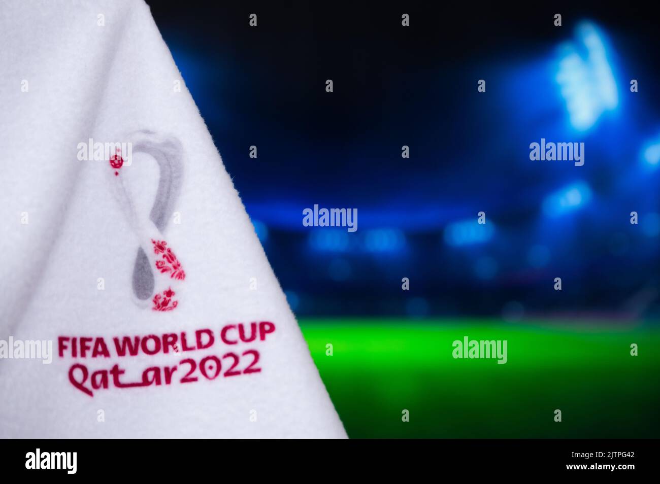 DOHA, QATAR, AUGUST 30, 2022: Fifa world Cup 2022 in Qatar. Football World Championship official logo on white blanket. Dark Soccer Stadium in backgro Stock Photo
