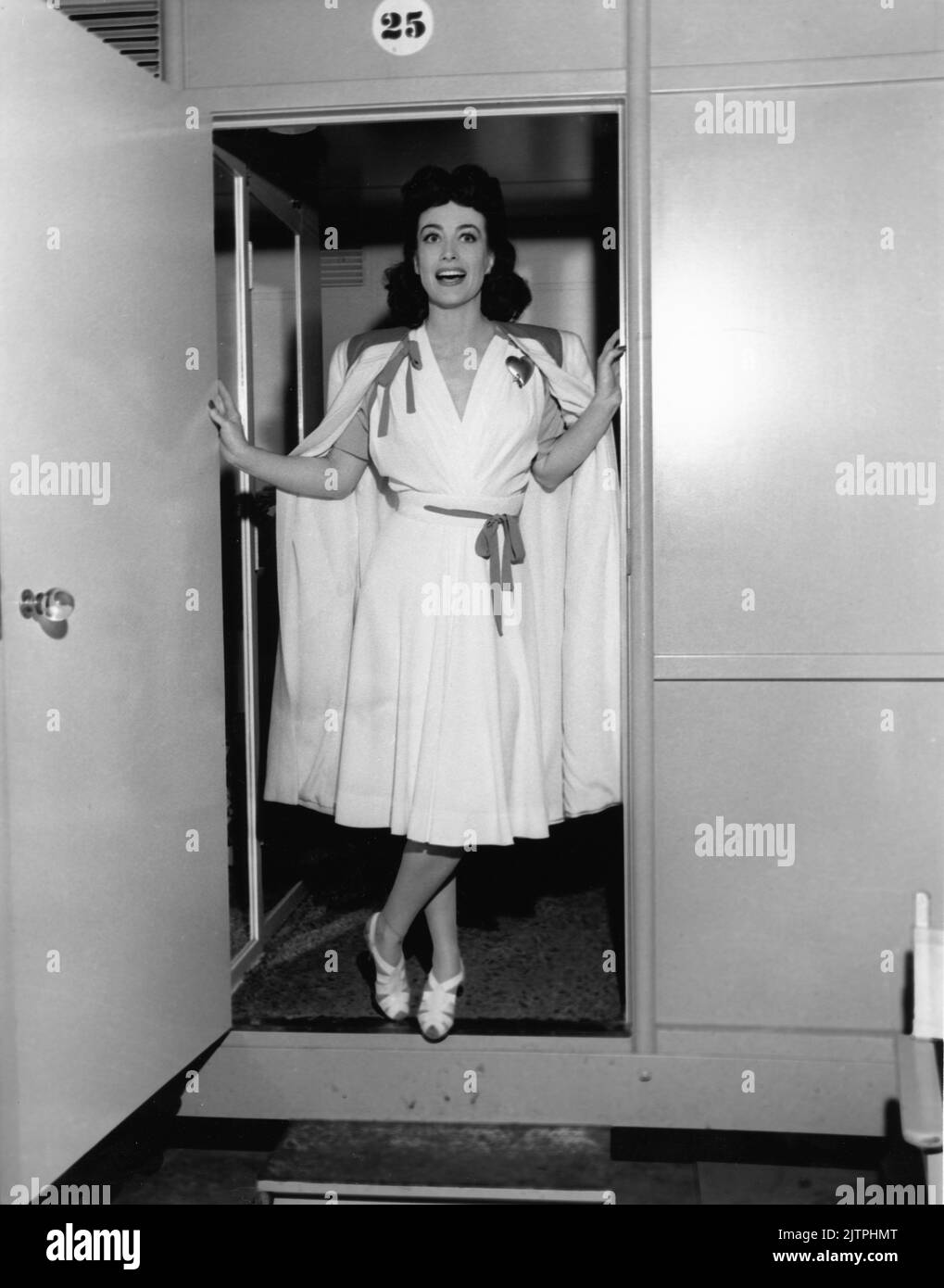JOAN CRAWFORD on set candid standing at her Dressing Room door during filming of THEY ALL KISSED THE BRIDE 1942 director ALEXANDER HALL Columbia Pictures Stock Photo