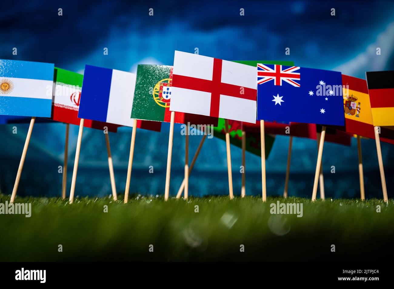 Football Wallpaper. Ball and national lags of top world soccer countries. Wallpaper for Tournament in Qatar. Black edit space in Background Stock Photo