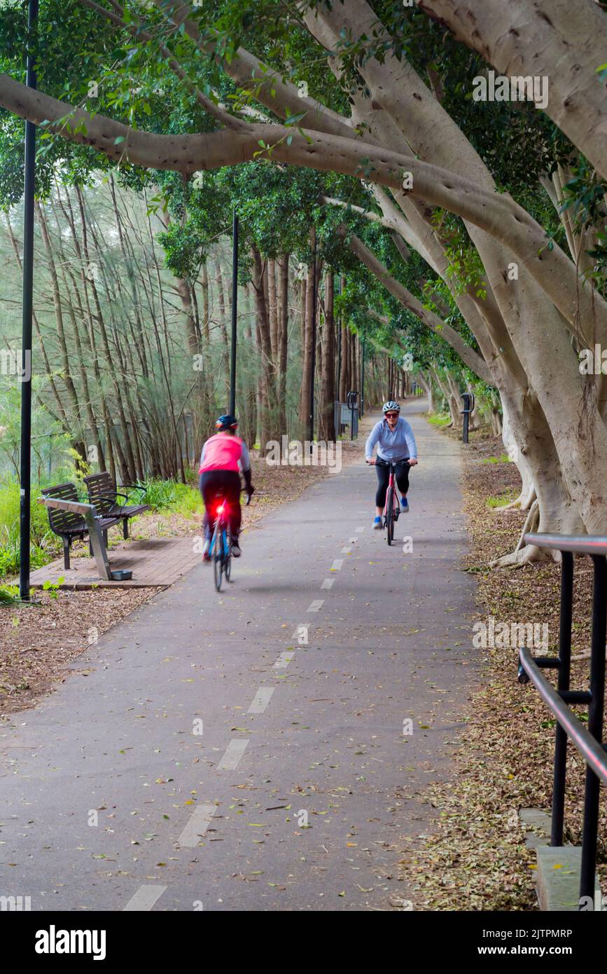 People riding on the shared bike (bicycle) and pedestrian path that follows the 1891 built  Hawthorne Canal in Sydney, Australia Stock Photo