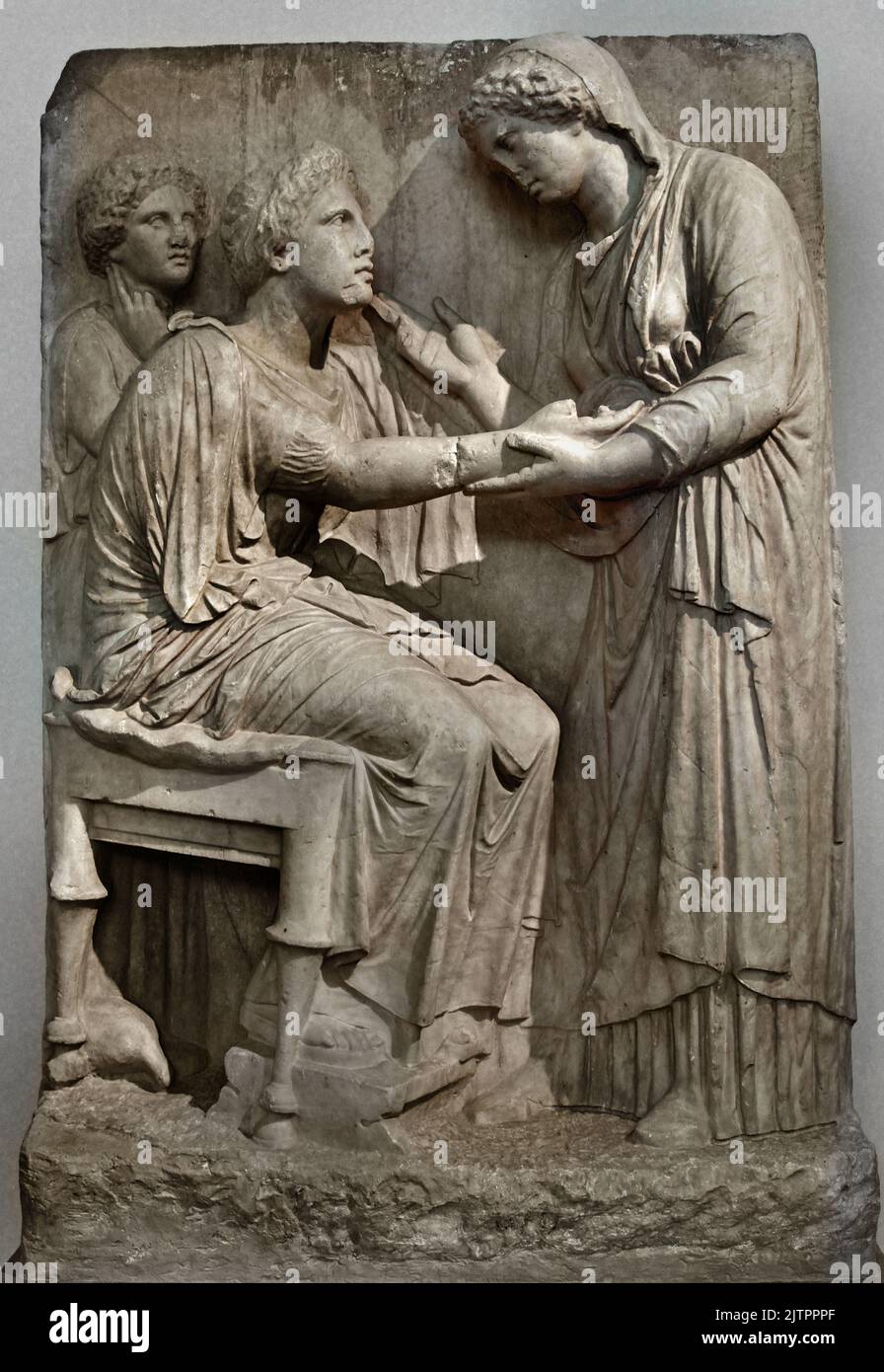 Funerary Stele of Farewell 4th cent. B.C. National Archaeological Museum in Athens,  Found, Omonoia Square, Athens. A woman seating on a stool extends her right hand to a standing relative, who holds it tenderly at the wrist and raises her other hand in a gesture of speech, At the left stands a girl lost in reflection. A small partridge pecks at the ground beneath the dead woman’s seat, Stock Photo