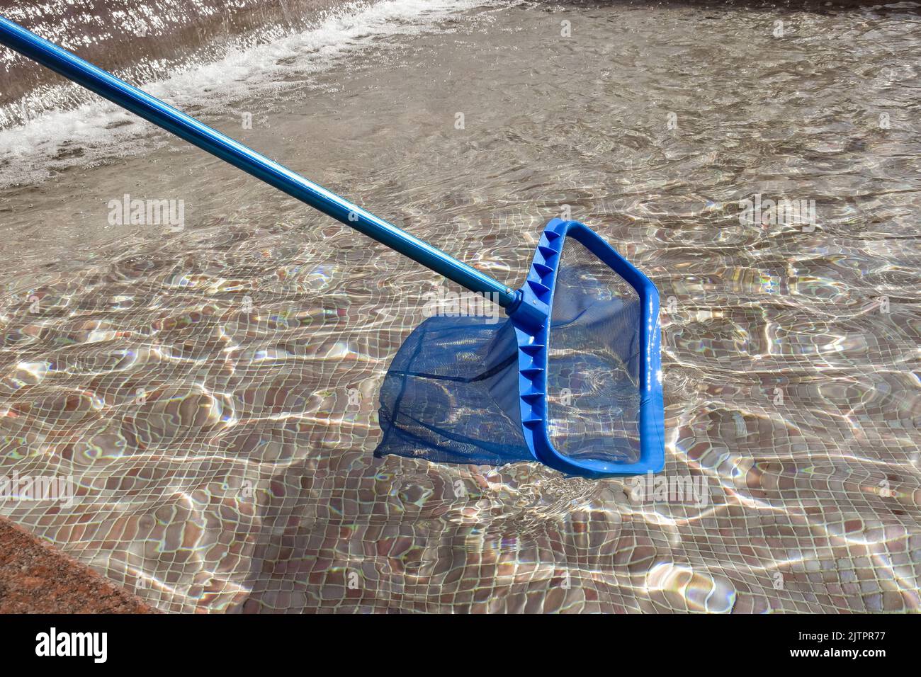 Mesh net for cleaning pool from debris. Cleaning pool, city fountain