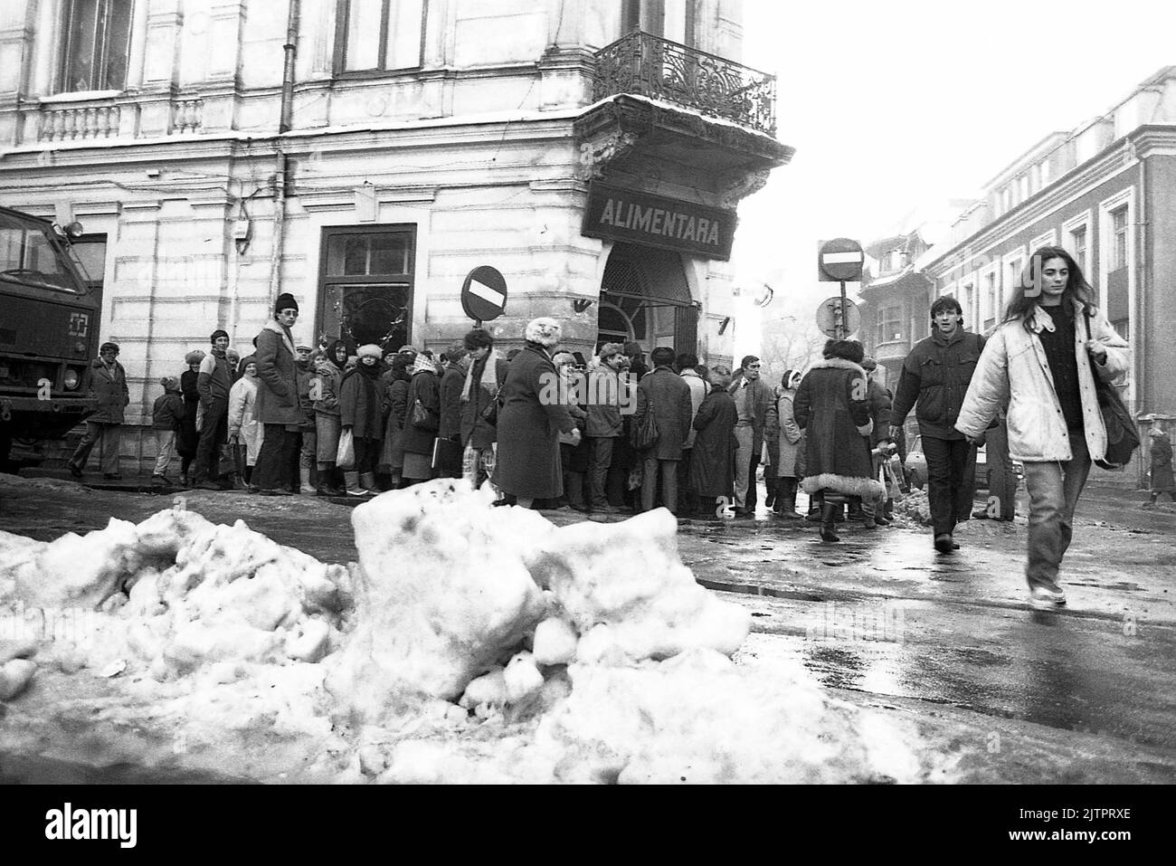 Bucharest, Romania, January 1990. Less than a month after the anti-communist revolution of December 1989, people still stay in long lines to get hold of basic groceries. The centralized socialist economic system created scarcity and hunger. Stock Photo