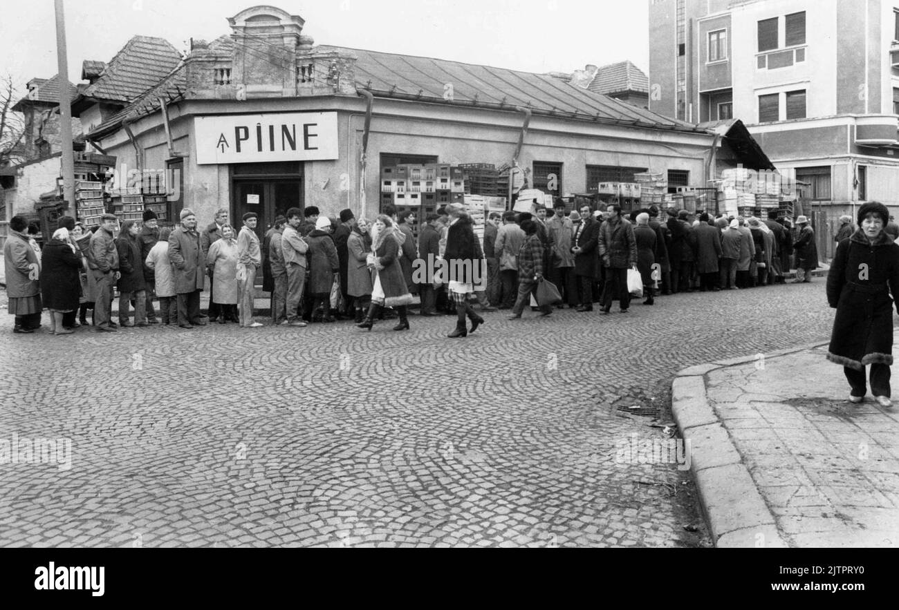 Bucharest, Romania, January 1990. Less than a month after the anti-communist revolution of December 1989, people still stay in long lines to get hold of basic groceries. The centralized socialist economic system created scarcity and hunger. Here, a line in front of a bread store. Stock Photo