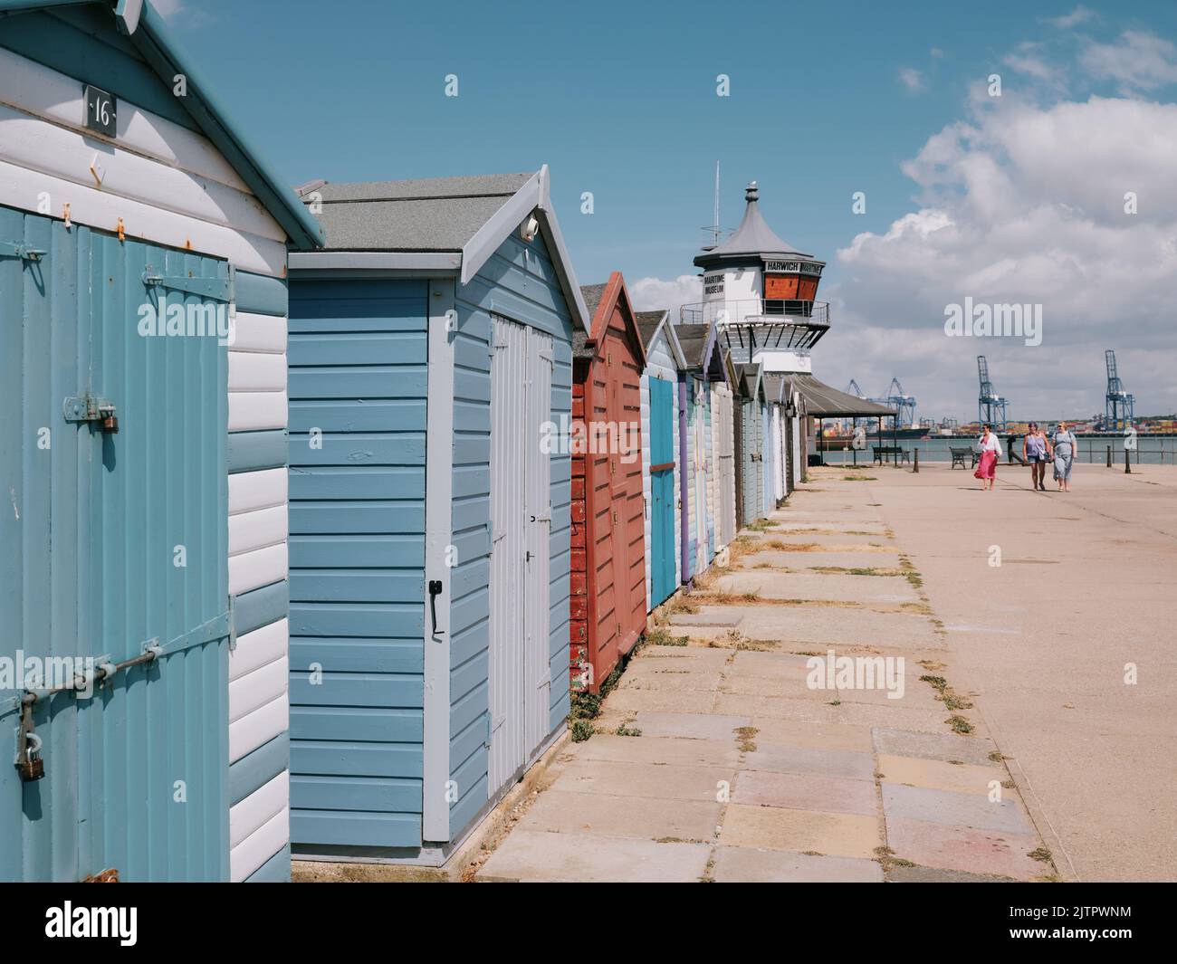Harwich Low Lighthouse and painted beach huts on the seafront in