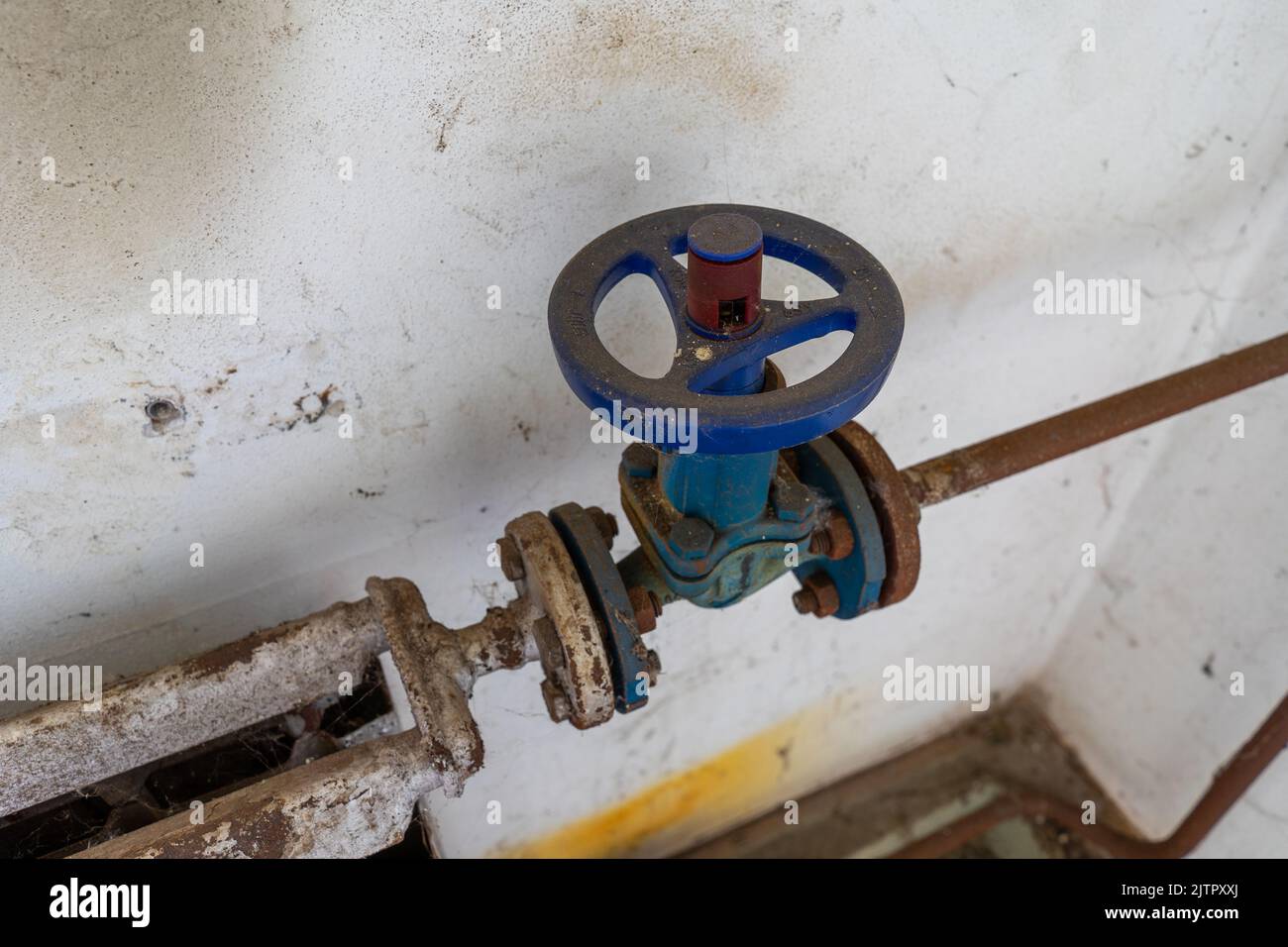 Old rusted heater valve with pipe Stock Photo