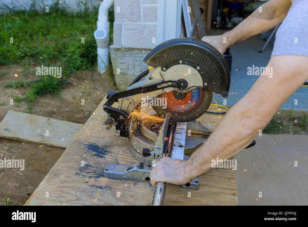 Miter saw with worker a cutting of iron pipe Stock Photo Alamy