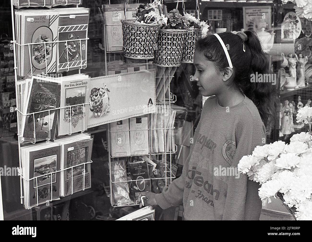 Girl buying greeting card, UK, 1987 Stock Photo
