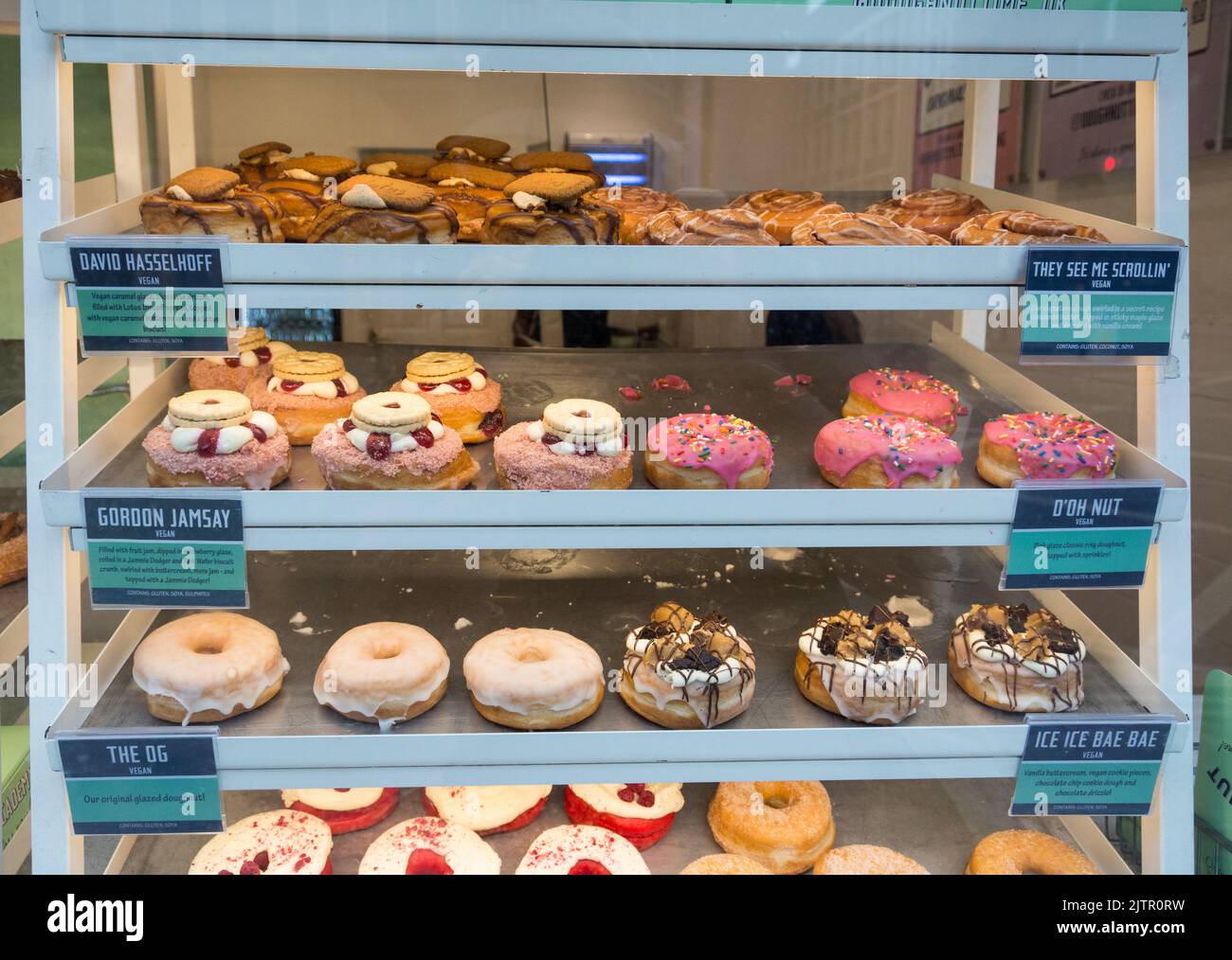 Colourful doughnuts in a Doughnut Time shop window on Fleet Street, London, England, UK Stock Photo