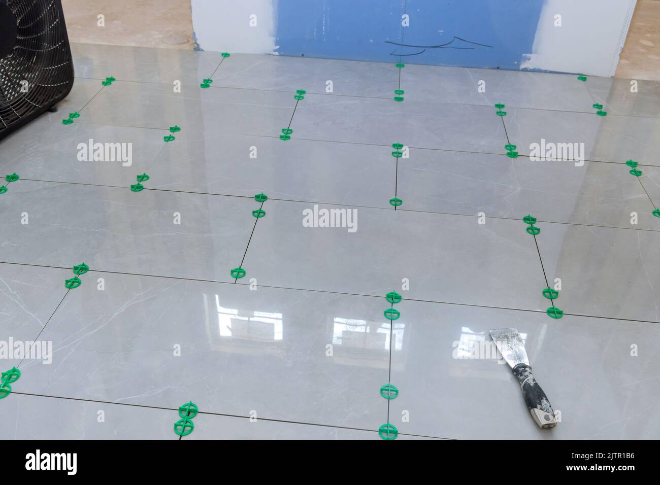 Currently under construction is a new house that has laying ceramic