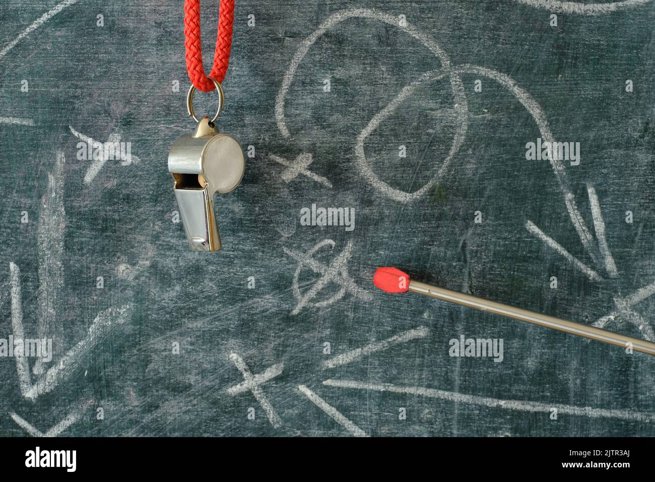 Whistle of soccer coach or referee and soccer tactics scribble on black board. Great soccer event this year. Stock Photo