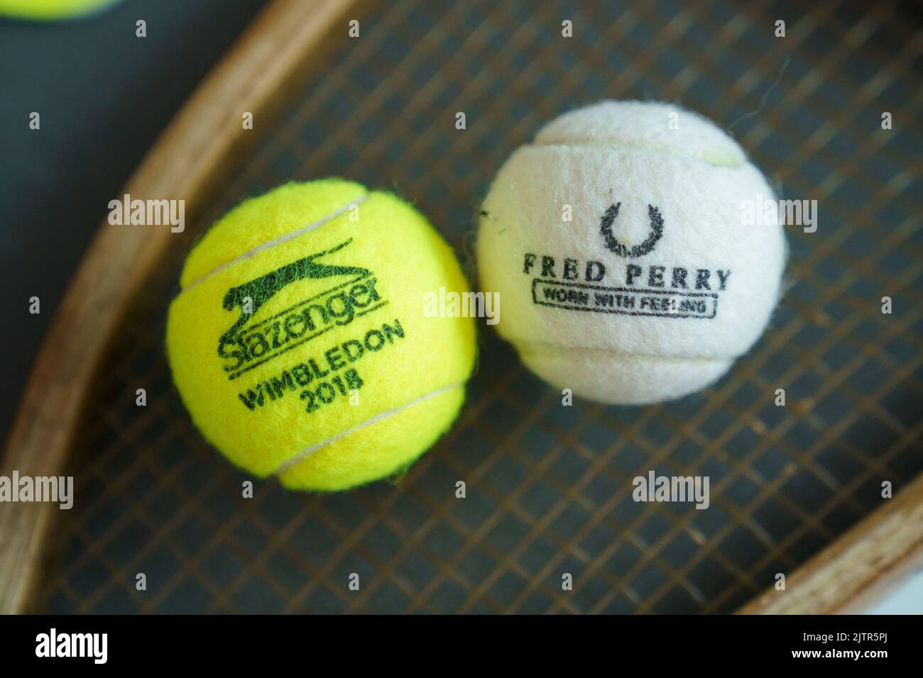 Fred Perry tennis ball and old wooden racket at Wimbledon Championships Stock Photo
