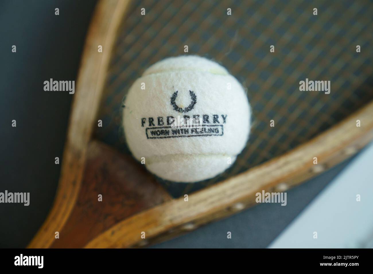 Fred Perry tennis ball and old wooden racket at Wimbledon Championships Stock Photo
