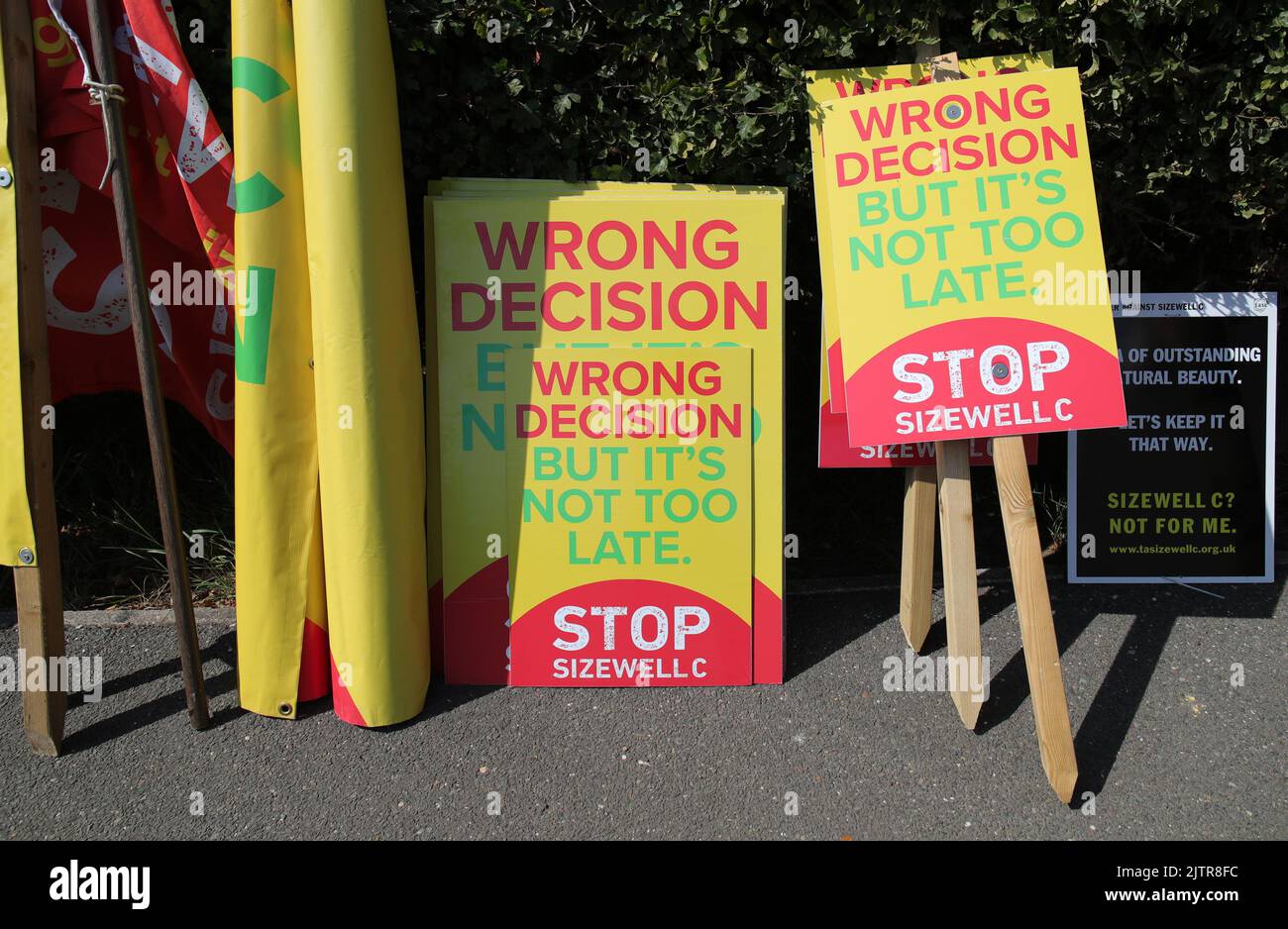 Placards belonging to protesters from the Stop Sizewell C and Together Against Sizewell C campaign groups outside EDF's Sizewell B nuclear power station in Suffolk, as Prime Minister Boris Johnson announced £700m of Government funding for a new reactor at the plant, during his visit. Picture date: Thursday September 1, 2022. Stock Photo