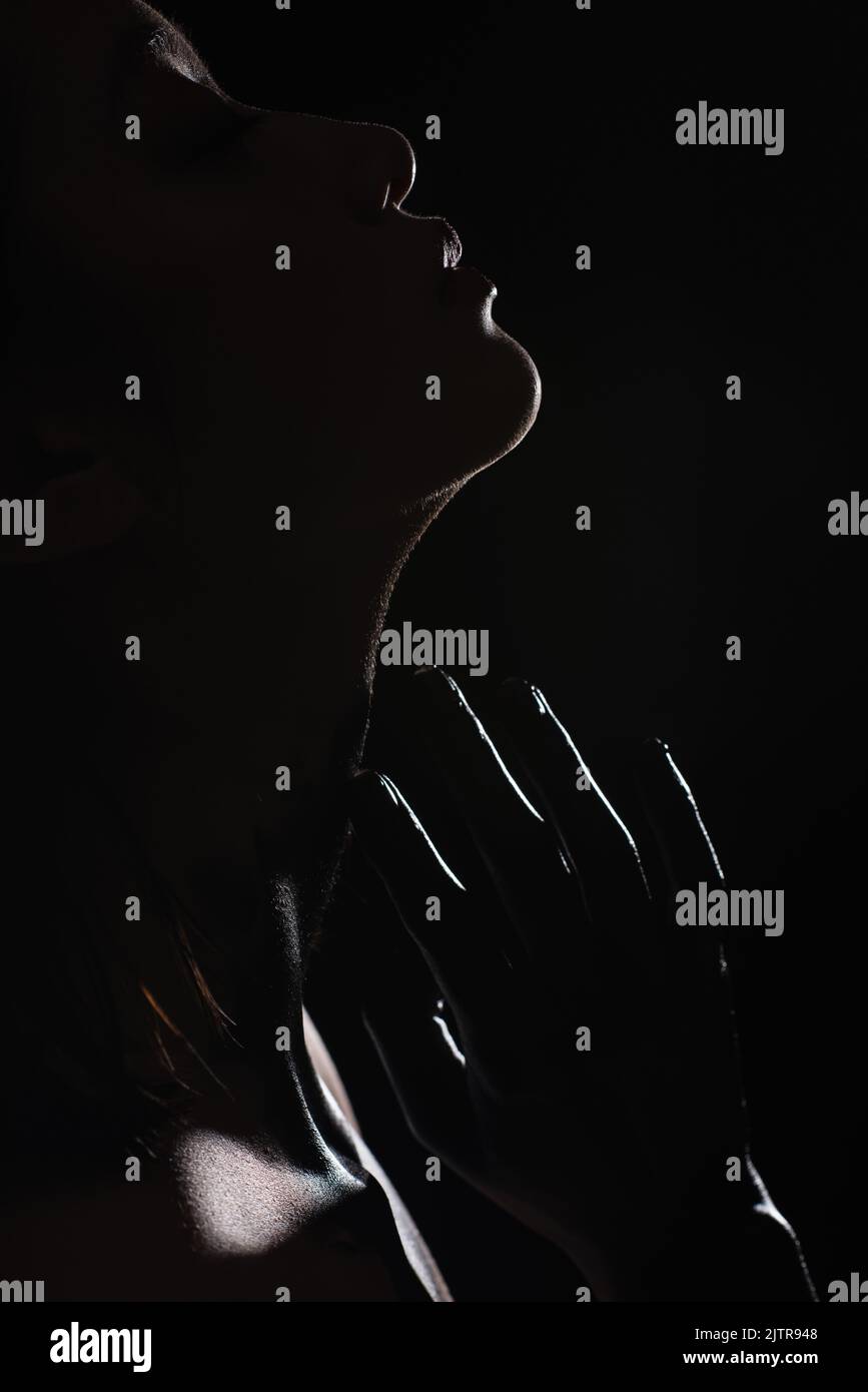 silhouette of young asian woman touching face isolated on black,stock image Stock Photo