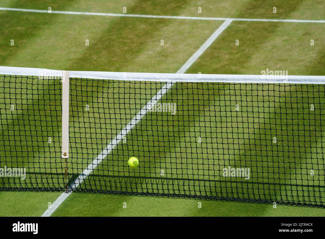 Tennis ball and net on No.2 Court at Wimbledon Championships 2022. Stock Photo