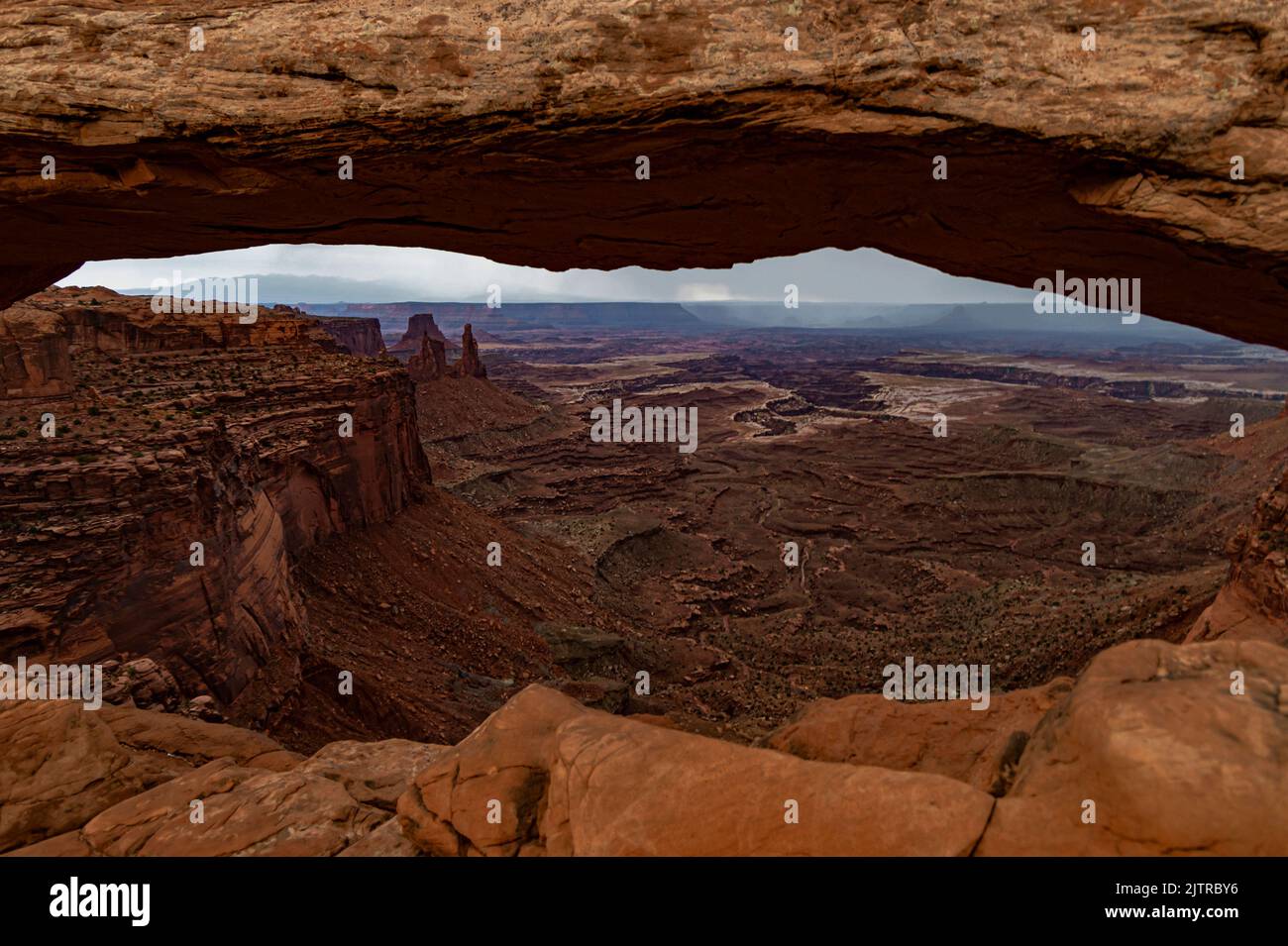 Mesa Arch is seen on of stormy overcast day, Canyonlands National Park, San Juan County, Utah Stock Photo