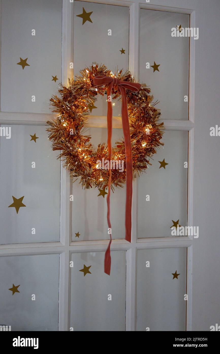 Handmade, lit tinsel wreath using an embroidery hoop, finishes with