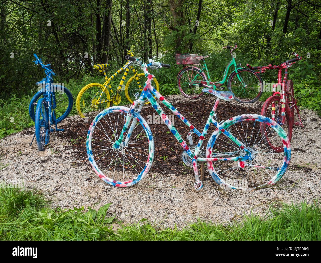 The image is of hand painted coloured bicycles on the riverside walk between Ramsau and Mayrhofen in the Zillertal valley of the Austrian Tirol Stock Photo