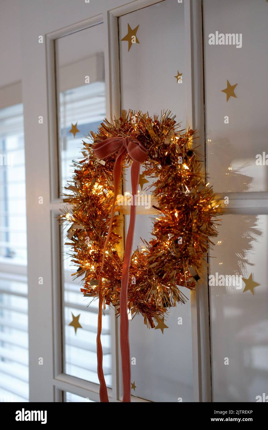 Handmade, lit tinsel wreath using an embroidery hoop, finishes with