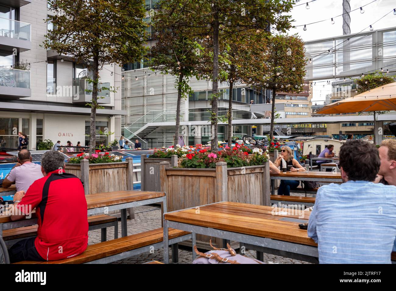 Paddington Basin, London. A regenerated area of Paddington, along the canal, with a walkway, cafes and restaurants along with modern apartments. Stock Photo