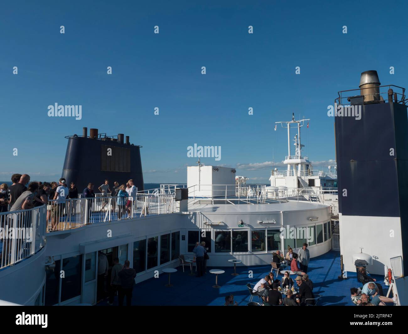 Rodbyhavn, Denmark, Agust 21, 2021: People enjoying the cruise and sun on the deck of the Scandlines Hybrid Ferry boat betweene Rodby - Puttgarden. Stock Photo