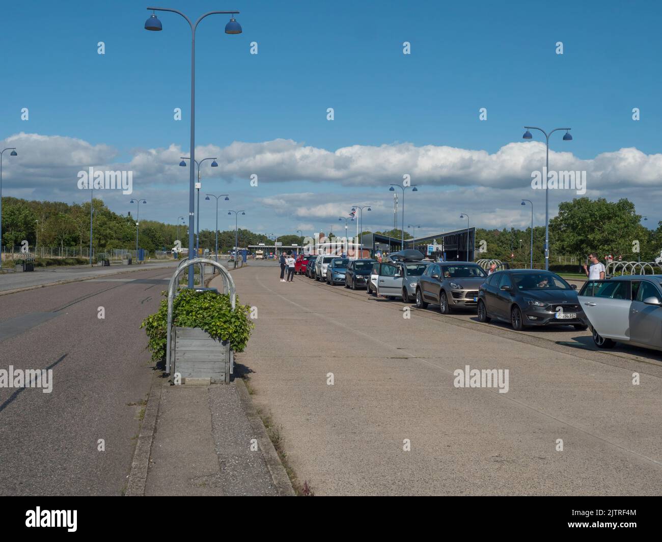 Rodbyhavn, Denmark, Agust 21, 2021: Queue of cars waiting to boad on Scandlines Hybrid Ferry boat on sea route Rodby - Puttgarden, between Denmark and Stock Photo