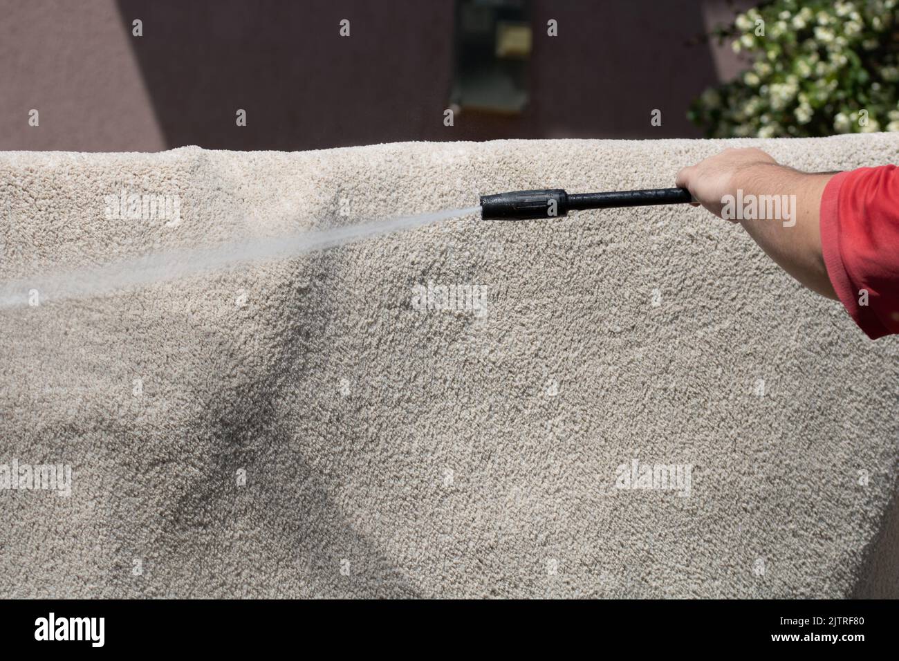 Washing carpets with high pressure washer. Cleaning the carpet with a