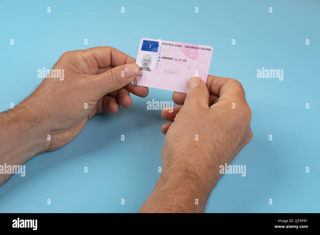a man with an Italian driving license in the hands Stock Photo