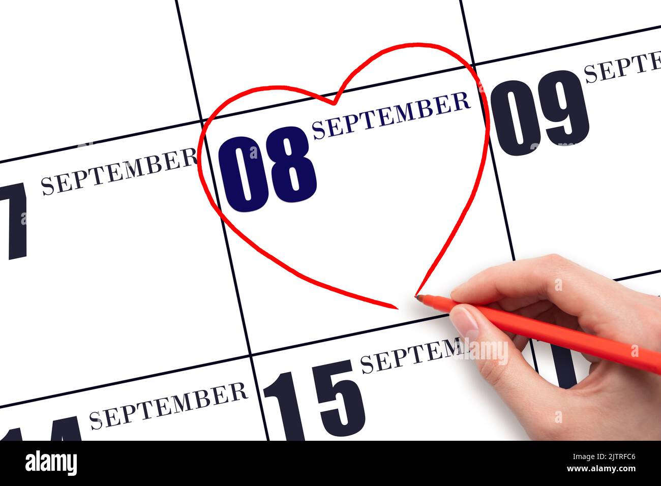 8th day of September. A woman's hand drawing a red heart shape on the ...