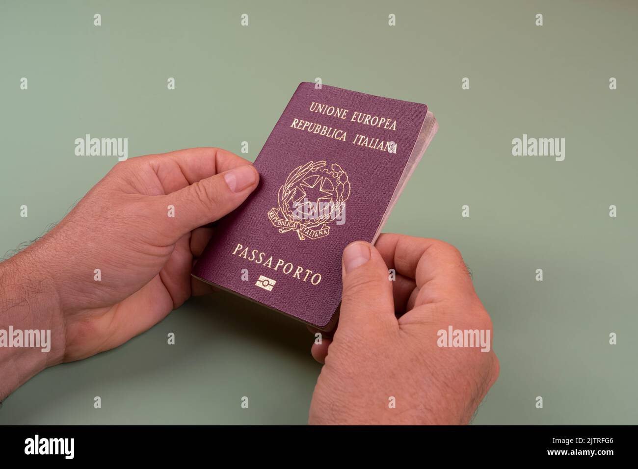 a man with an Italian passport in the hands Stock Photo