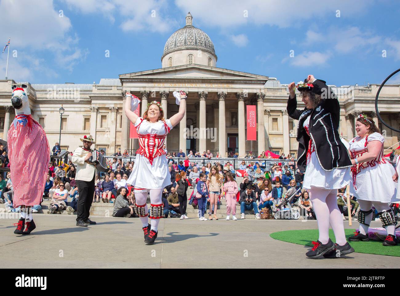 People watch Morris dancers as they gather for St George’s Day celebrations in Trafalgar Square, central London. Stock Photo