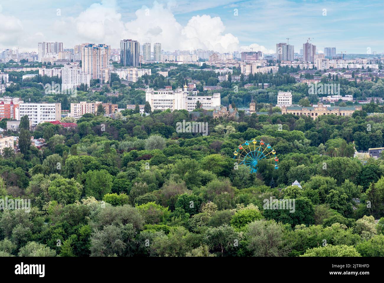 Kyiv cityscape with green area and old ferris wheel on foreground Stock Photo