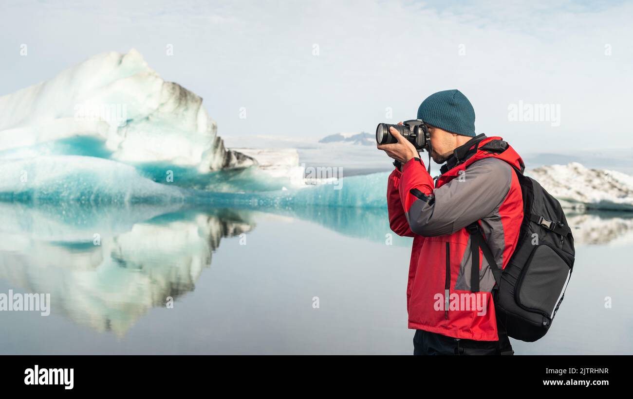Traveling in Iceland, photographer with DSLR camera in glacier lagoon