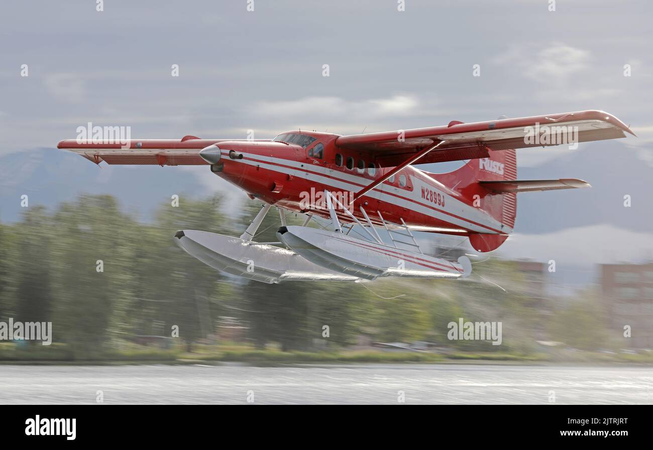 Seaplane taking off form a lake in Anchorage, Alaska Stock Photo