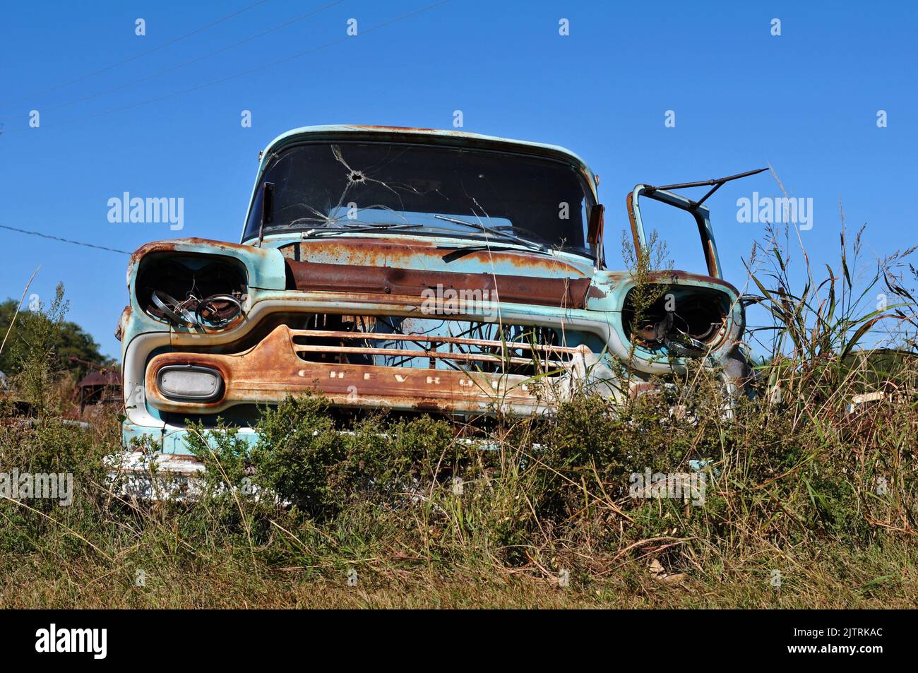 A rusting old Chevrolet truck sits abandoned in a field along Route 66 ...