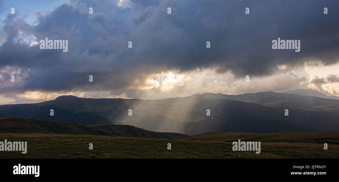 Beautiful ray of sunlight breaking through clouds at sunset Stock Photo ...