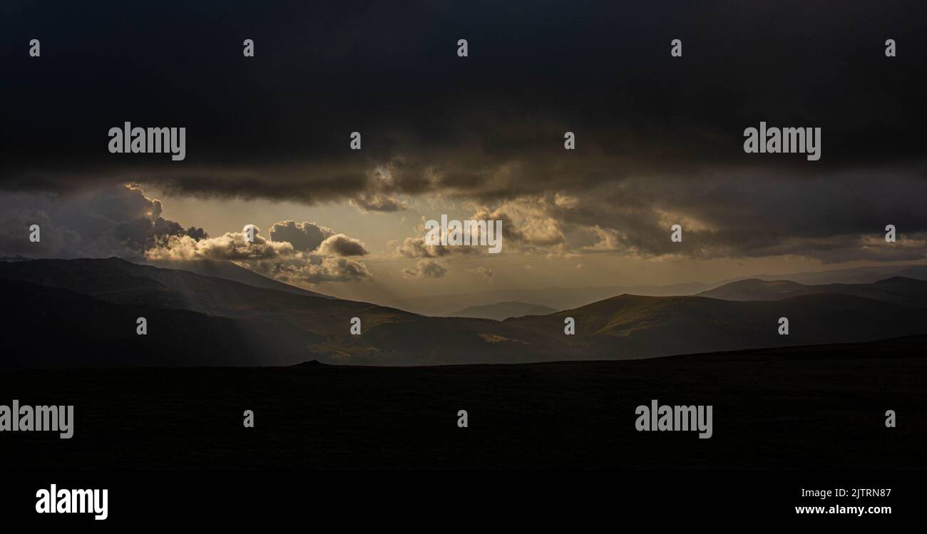 Beautiful ray of sunlight breaking through clouds at sunset Stock Photo ...