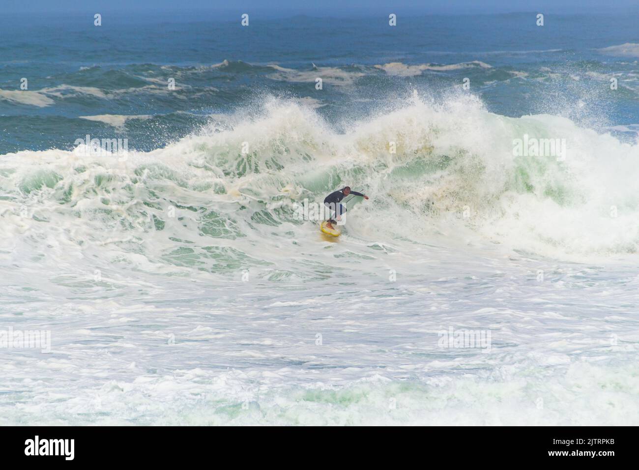 surfer riding a wave at leblon beach in Rio de Janeiro, Brazil - April 5, 2020: surfer riding a big wave during the surf that hit the city of Rio de J Stock Photo