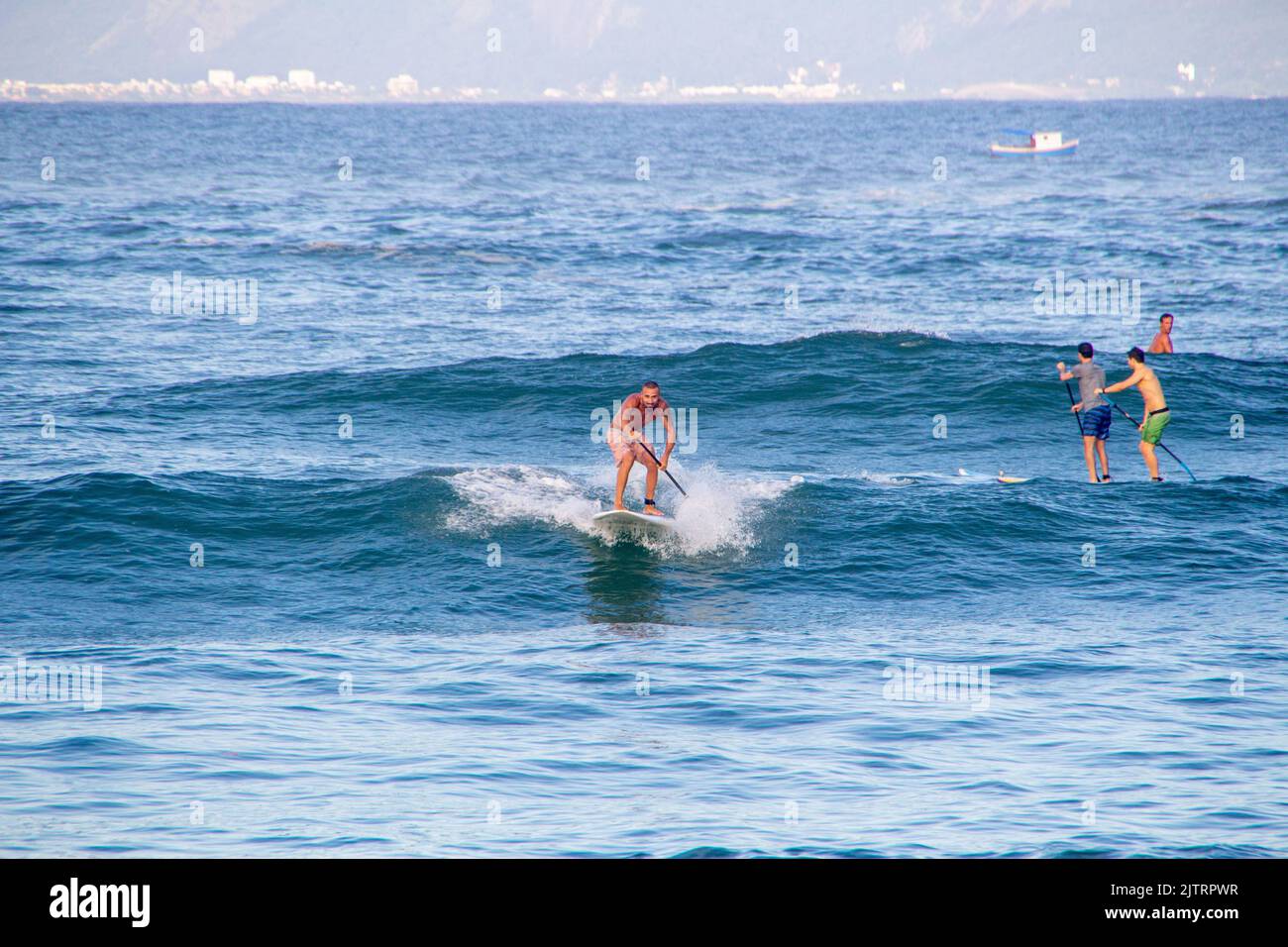 Man practicing stand up paddle at Copacabana beach in Rio de Janeiro, Brazil - March 7, 2020: Man practicing stand up paddle at post six on Copacabana Stock Photo