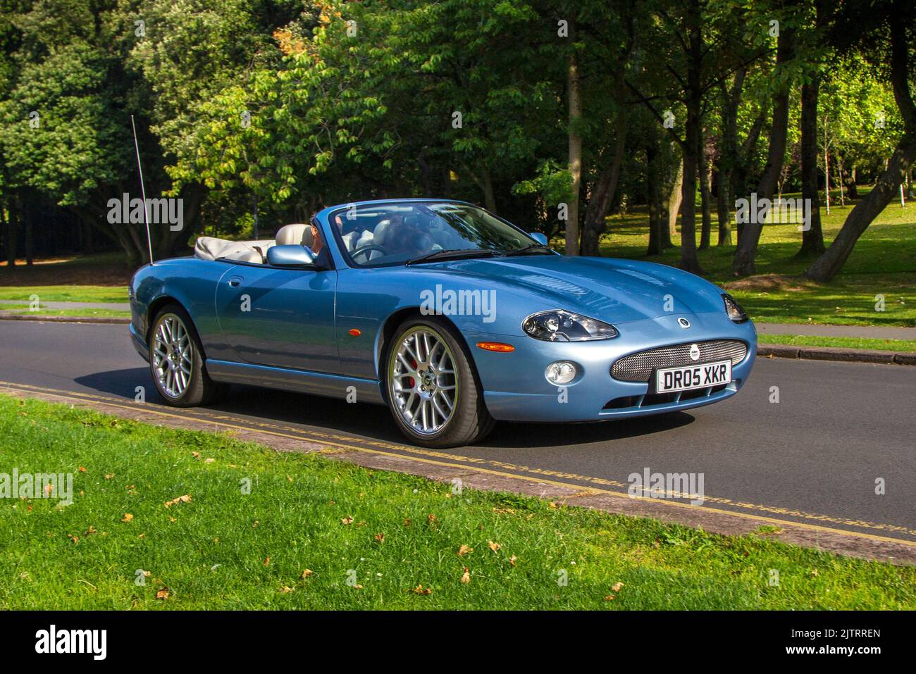 2005 Jaguar Xkr Convertible V8 S/C Auto arriving at the annual Stanley Park Classic Car Show. Stanley Park Classics Yesteryear Motor Show is hosted by Blackpool Vintage Vehicle Preservation Group, UK. Stock Photo