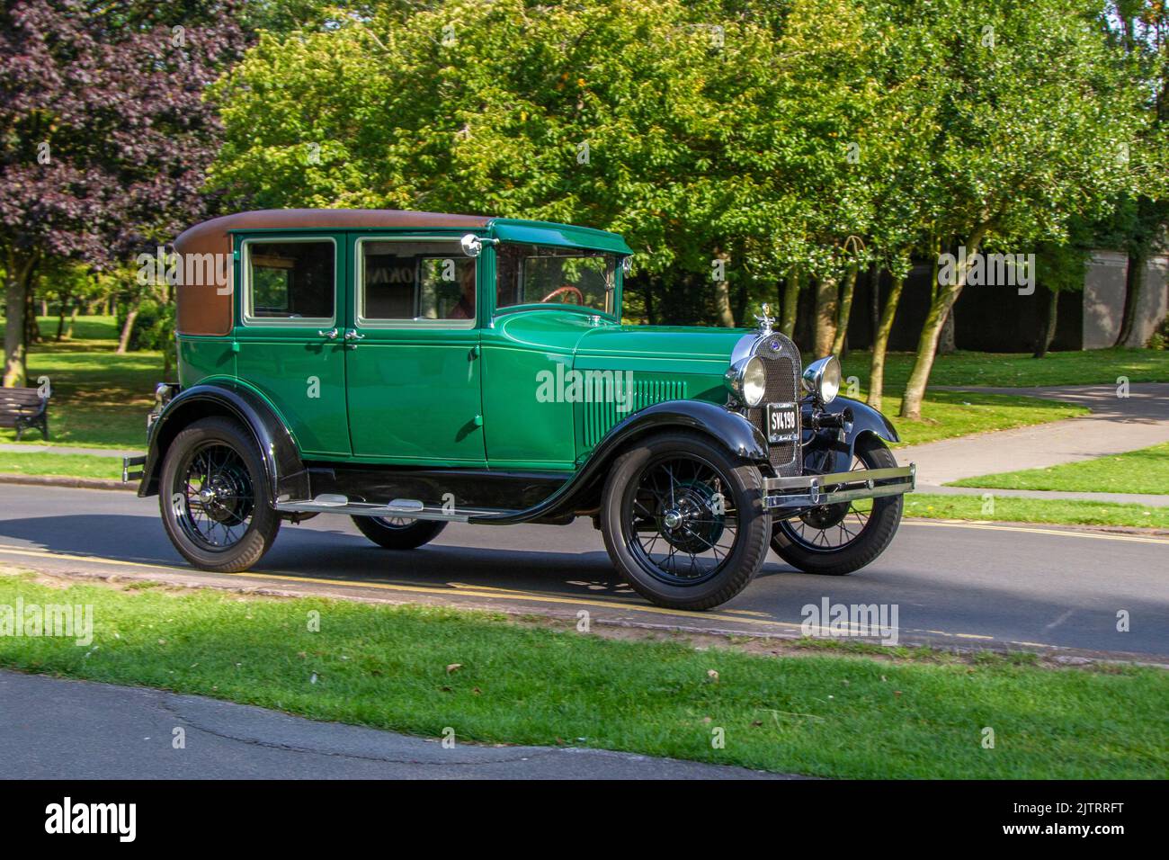 1928, 1920s, twenties pre-war Green Ford Sedan.  Ford Model A Phaeton; Cars arriving at the annual Stanley Park Classic Car Show. Stanley Park classics yesteryear Motor Show is hosted by Blackpool Vintage Vehicle Preservation Group, UK. Stock Photo