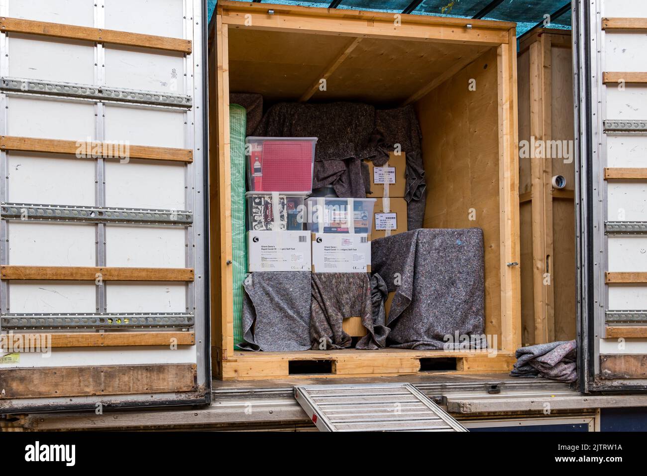Household items, furniture and boxes packed into lorry storage container for moving house, UK Stock Photo