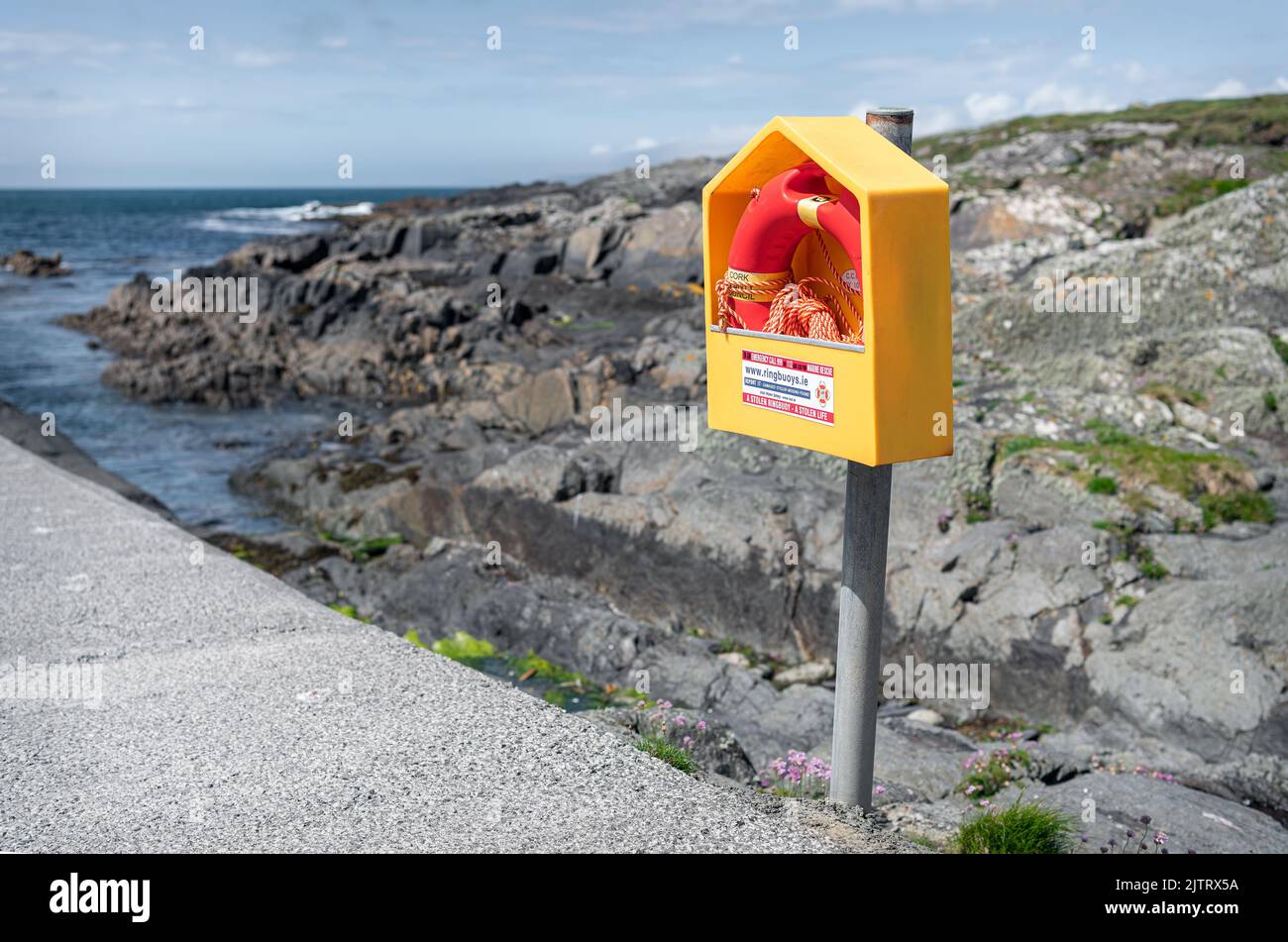 Standard Irish Emergency Life Ring in its storage box at Gortnakilla Pier, County Cork, Ireland Stock Photo