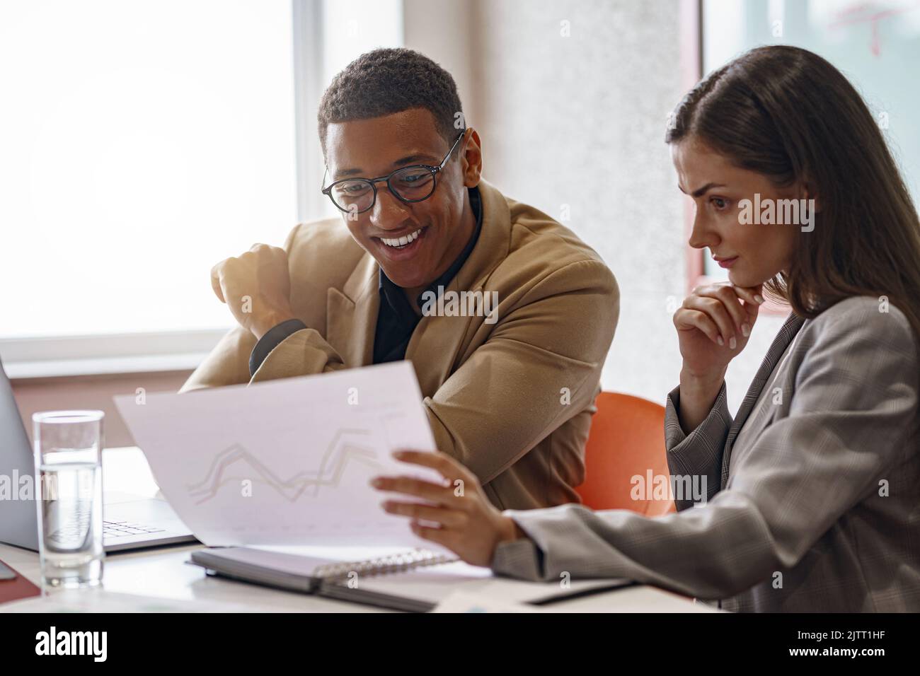 Smiling coworkers cooperating and working together at coworking space, teamwork concept Stock Photo