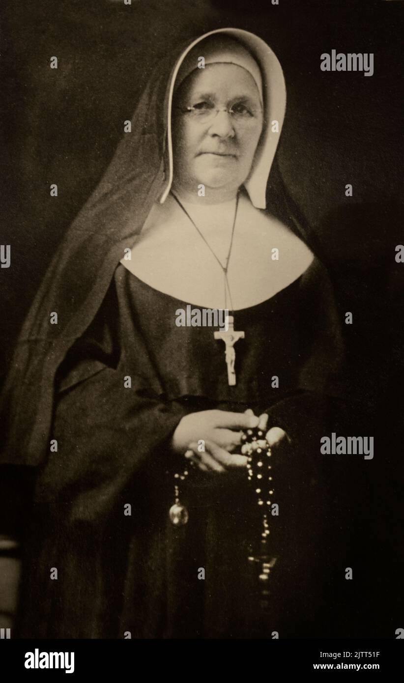 A vintage 1940s photograph of a Catholic nun holding rosary beads for sale in an antique shop in Santa Fe, New Mexico. Stock Photo