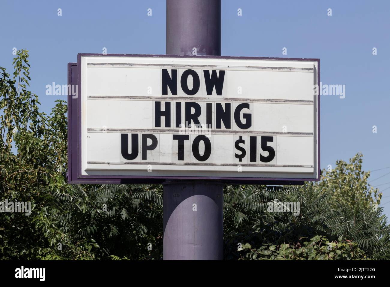 Now Hiring Up to 15 an hour sign. Amid a shortage of workers