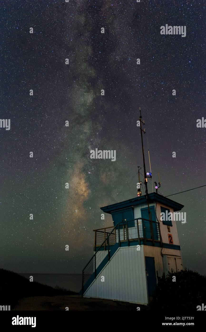 Milky way over a lifeguard tower in Malibu Stock Photo