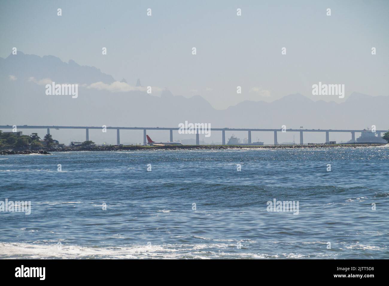 Guanabara Bay, Santos Dumont Airport, Rio x Niteroi Bridge, and the Serra dos Orgaos in the background in Rio de Janeiro. Stock Photo