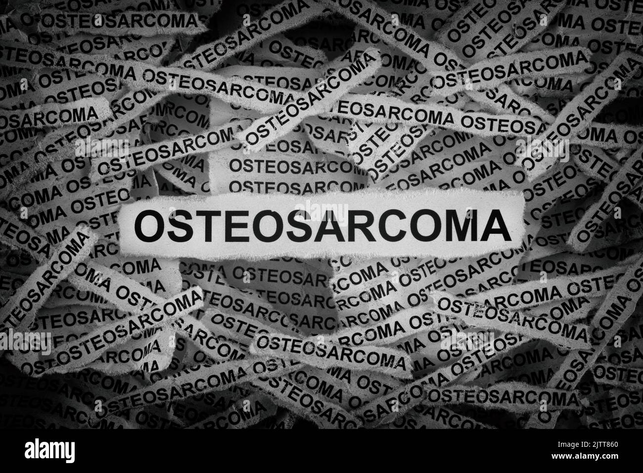 Strips of newspaper with the words Osteosarcoma typed on them. Black and white. Close up. Stock Photo